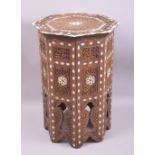 A MOORISH OCTAGONAL BONE INLAID AND CARVED TABLE, 32cm diameter, 49cm high.