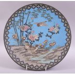 A JAPANESE CLOISONNE CIRCULAR DISH, decorated with birds and native flora, 30cm diameter.