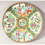 A CHINESE CANTON PORCELAIN PLATE, decorated with panels of figures, birds, butterflies and
