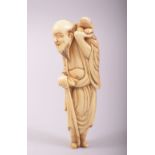 AN 18TH CENTURY CARVED IVORY SASHI NETSUKE of a sage holding a frog aloft, 9cm long.