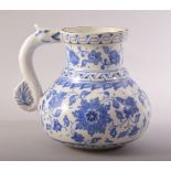 A TURKISH OTTOMAN IZNIK BLUE AND WHITE MASRAPA WATER JUG, painted with scrolling foliate decoration,