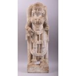 AN EARLY INDIAN CARVED STONE STATUE OF A FEMALE holding a musical instrument, 66cm high.