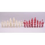 A VERY GOOD 19TH CENTURY CHINESE CARVED AND STAINED IVORY CHESS SET, each piece standing on a