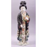 A JAPANESE KUTANI PORCELAIN FIGURE, modelled as a standing female figure holding two books, 45cm