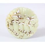 A CHINESE CARVED JADE DISK / PENDANT - Carved with birds aside foliage. 6.5cm