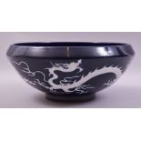 A VERY LARGE CHINESE SACRIFICIAL BLUE GLAZED BOWL, the exterior decorated with white dragons, 38cm