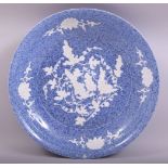 A LARGE CHINESE MOTTLED BLUE GLAZED AND INCISED DISH, the dish with carved decoration depicting