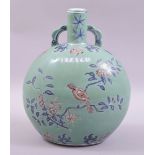 A CHINESE TURQUOISE GROUND BLUE AND IRON RED UNDERGLAZE TWIN HANDLE MOON FLASK, decorated with birds