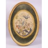 A CHINESE OVAL SILK WORK PICTURE, embroidered with a floral bouquet, framed and glazed, overall 55cm