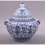 A CHINESE BLUE AND WHITE TWIN HANDLE PORCELAIN JAR AND COVER, decorated with eight treasure
