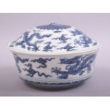 A CHINESE BLUE AND WHITE PORCELAIN BOWL AND COVER, decorated with dragons amongst stylised clouds,