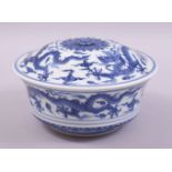 A CHINESE BLUE AND WHITE PORCELAIN BOWL AND COVER, decorated with dragons amongst stylised clouds,