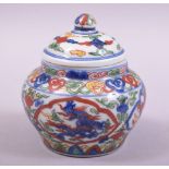 A SMALL CHINESE PORCELAIN DOUCAI POT AND COVER, decorated in the doucai palette with dragons, the
