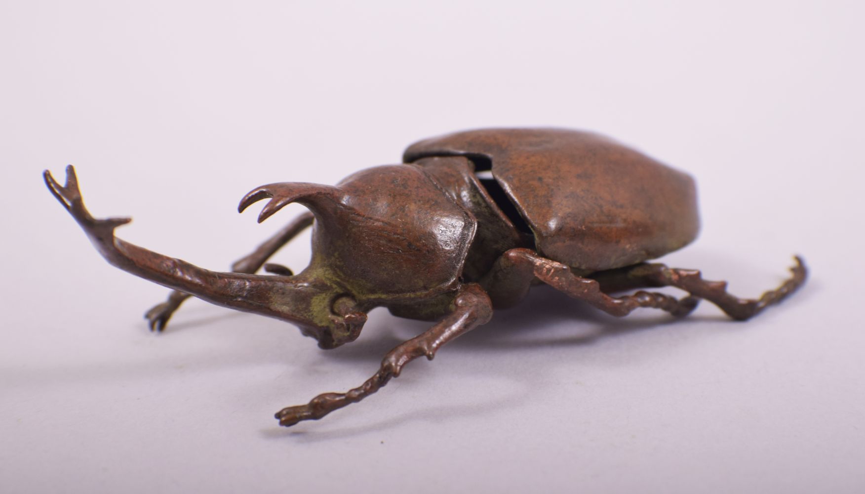 A JAPANESE BRONZE MODEL OF BEETLE; rhinoceros beetle, with an opening hinged back section, 10cm