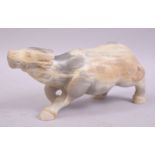 A CHINESE HARDSTONE OR WHITE JADE CARVING OF A BUFFALO, 23cm long.