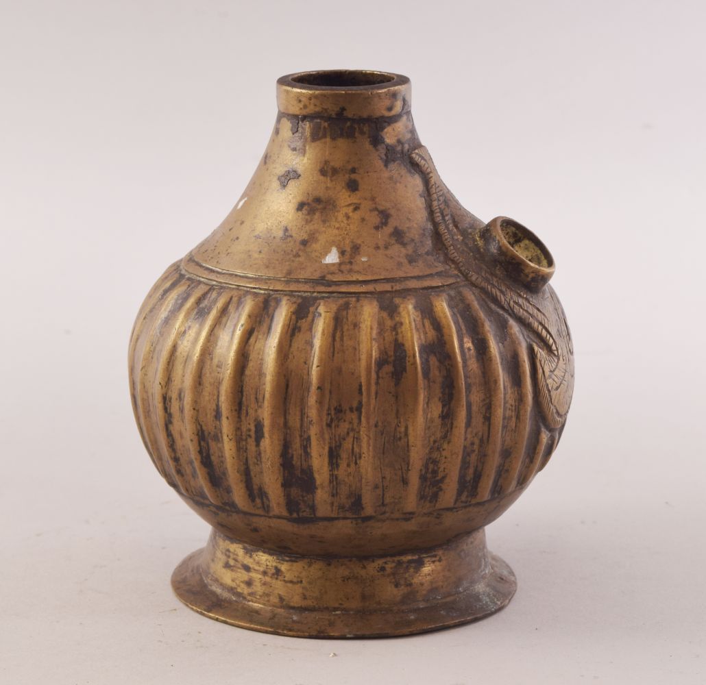 A 18TH CENTURY MUGHAL BRASS HUQQA BASE, with a ribbed body, 13cm high.