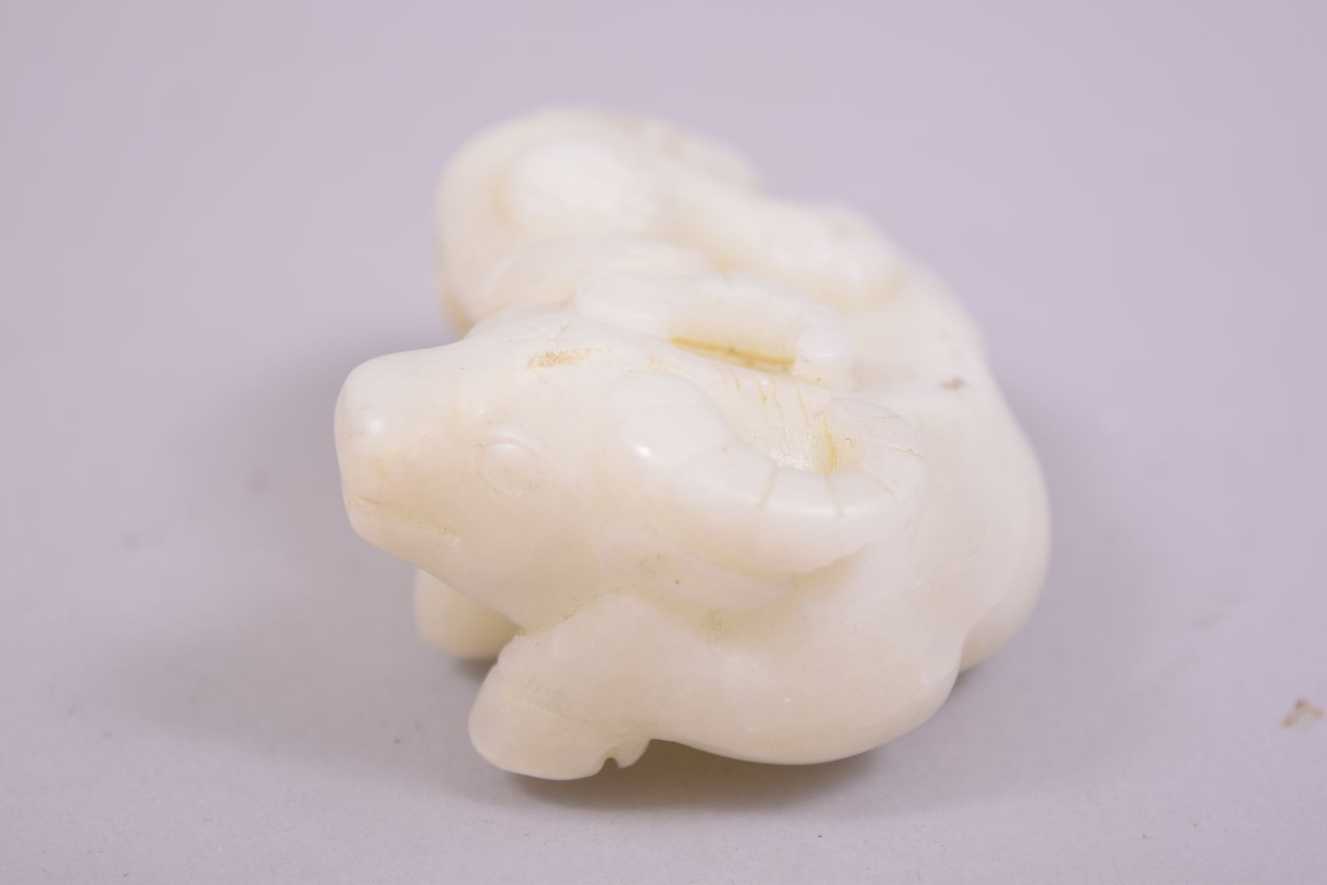 A SMALL CHINESE JADE CARVING OF A BUFFALO, with a figure astride, 8cm long. - Image 4 of 5