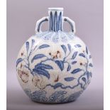 A CHINESE MING STYLE BLUE AND WHITE AND UNDER GLAZED RED TWIN HANDLE MOONFLASK VASE, decorated