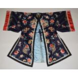 A VERY GOOD QUALITY CHINESE EMBROIDERED BLUE SILK KIMONO, embroidered with bats, fruit and flowers.
