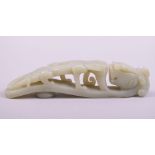 A CHINESE CARVED JADE DARGON FORMED BUCKLE, 14cm long.