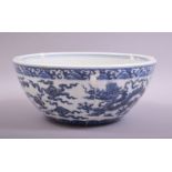 A LARGE CHINESE BLUE AND WHITE DRAGON BOWL, the exterior painted with dragons amongst stylised