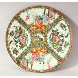 A CHINESE CANTON PORCELAIN PLATE, painted with panels of figures, birds and butterflies, 30.5cm.