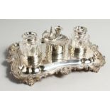 A SUPERB WILLIAM IV SILVER INKWELL with two silver glass bottles and shell shaped chamber stick.