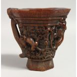 A LARGE CARVED HORN LIBATION CUP.