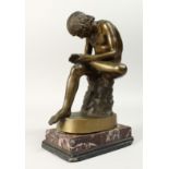 A GRAND TOUR BRONZE "Picking a thorn out of his foot", on a marble base. 9.5ins high.