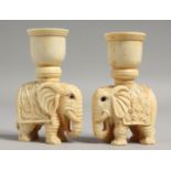 A PAIR OF CARVED BONE ELEPHANT CANDLESTICKS. 3.5ins high.