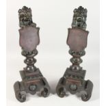 A SUPERB PAIR OF 19TH CENTURY BRONZE ANDIRONS with lion holding shields on curving feet.