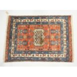 A PERSIAN ARDABIL RUG, rust ground with stylised design all over. 5ft 3ins x 3ft 11ins.