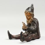 A 19TH CENTURY AUSTRIAN POTTERY SEATED PIXIE. 6ins high.