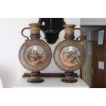 A GOOD LARGE PAIR OF METTLACH GERMAN POTTERY MOON FLASK SHAPED EWERS.