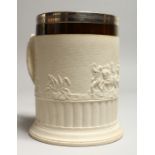 AN 18TH CENTURY POTTERY MUG with a scene of classical figures and chariots in relief with plated