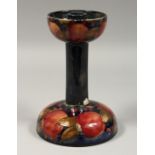 A MOORCROFT LIBERTYS POMMEGRANATE CANDLESTICK, impressed Moorcroft, with paper label. 8ins high (