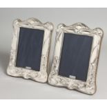 A PAIR OF ART NOUVEAU DESIGN SILVER PHOTOGRAPH FRAMES. 7.5ins x 5.5ins.