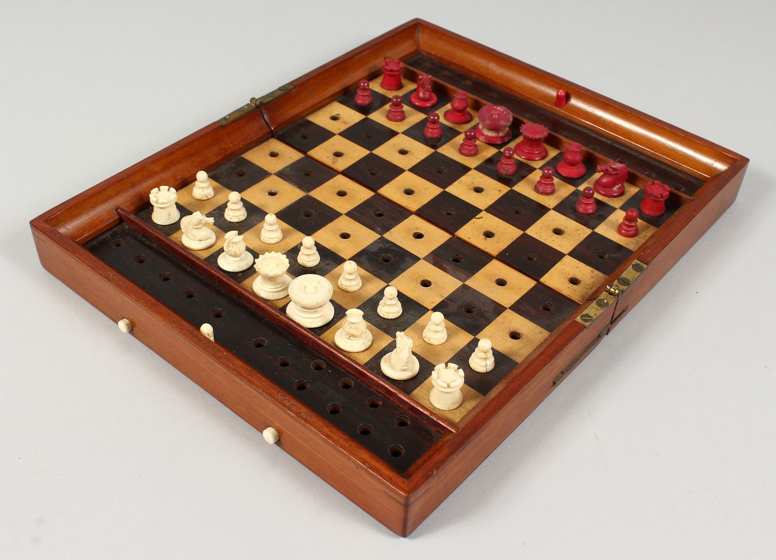 A JACQUES TRAVELLING CHESS SET AND FOLDING CASE BOARD.