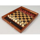 A JACQUES TRAVELLING CHESS SET AND FOLDING CASE BOARD.