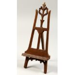 A MINIATURE WOODEN FOLDING EASEL. 11ins high.