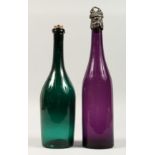 TWO EARLY COLOURED GLASS BOTTLE DECANTERS and stoppers. 12ins high.