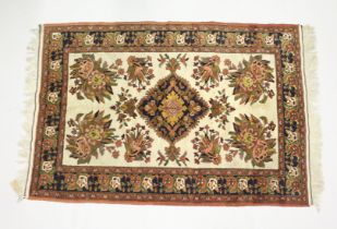 A PERSIAN RUG, cream ground with large floral decoration. 6ft x 4ft 1ins.
