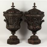 A VERY GOOD PAIR OF TWO HANDLED CARVED WOOD URNS AND COVERS with pineapple finials and carved with