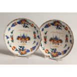 A PAIR OF 18TH CENTURY DUTCH DELFT TIN GLAZED PLATES with coloured enamels. 8.5ins diameter.