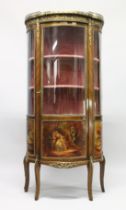 A VICTORIAN LOUIS XV STYLE BOW FRONTED VITRINE with ornate mounts, 3/4 glass doors and sides with
