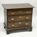 AN 18TH CENTURY OAK AND MAHOGANY CROSSBANDED CHEST OF DRAWERS with a rounded rectangular top, over a