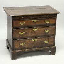 AN 18TH CENTURY OAK AND MAHOGANY CROSSBANDED CHEST OF DRAWERS with a rounded rectangular top, over a