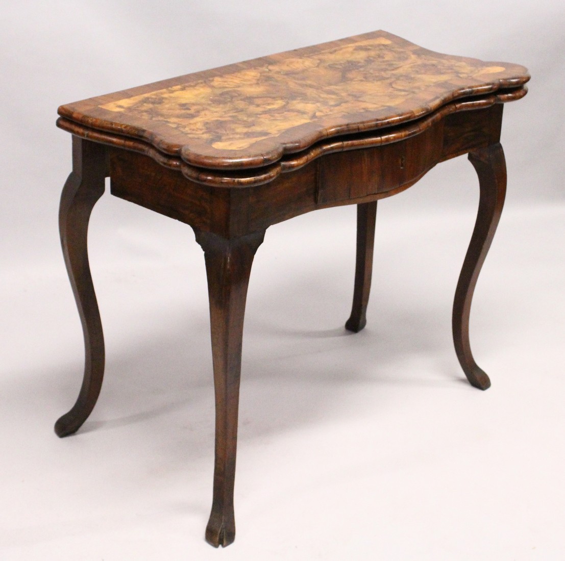 AN 18TH CENTURY ITALIAN FIGURED WALNUT FOLD-OVER CARD / TEA TABLE, of serpentine outline, with a - Image 2 of 5