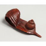 A JAPANESE CARVED WOOD SNAIL ON A LEAF. 4.5ins long