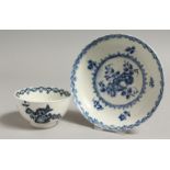 AN 18TH CENTURY WORCESTER TEABOWL AND SAUCER painted in blue with fruit and wreath pattern, crescent
